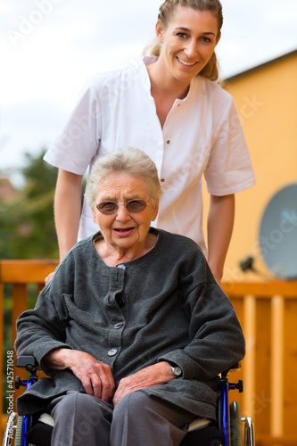 Photo: Young nurse and female senior in a wheel chair Young nurse and female senior in a wheel chair