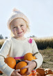Portrait of a girl holding pumpkins