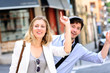 Young couple hailing for a taxi cab