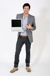 Young businessman pointing at laptop screen