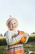 Portrait of a happy girl holding pumpkins