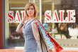 Young woman against a shop window