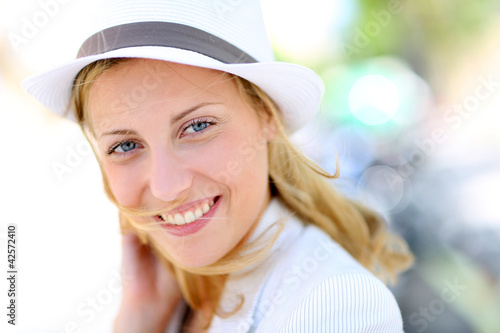 Photo: Closeup of beautiful young woman with hat Closeup of beautiful young woman with hat