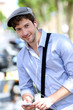 Young trendy guy talking on mobilephone in the street