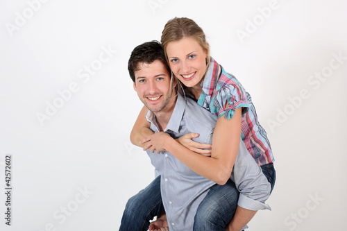 Photo: Young man carrying girlfriend on his back Young man carrying girlfriend on his back