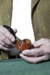 Photo: Close-up view of owner holding tobacco pipe Close-up view of owner holding tobacco pipe