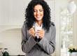 Foto: Young woman drinking a coffee at home Young woman drinking a coffee at home
