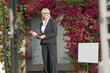 Photo: Portrait of a happy senior woman standing with clipboard Portrait of a happy senior woman standing with clipboard