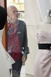 Foto: Senior man looking at wedding dress displayed on window in bridal store Senior man looking at wedding dress displayed on window in bridal store