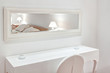 Modern furniture the bedroom. The mirror, bed, chair.