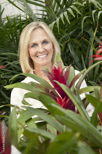Photo: Portrait of a cheerful senior woman in garden center Portrait of a cheerful senior woman in garden center