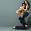 Sexy young couple wearing jeans on gray background