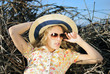 beautiful girl in shorts and hat on grapevine