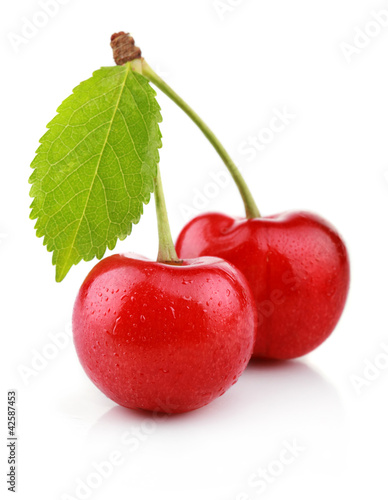 Photo: Ripe cherry berries with green leaf isolated on white Ripe cherry berries with green leaf isolated on white