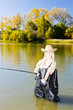 woman fishing in pond