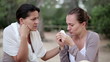 Young woman comforting tearful friend, outdoors