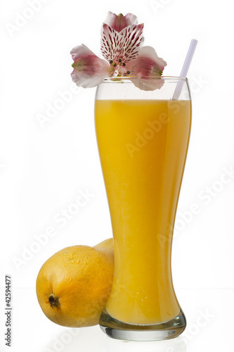 Photo: glass of mango juice and decorated with flowers glass of mango juice and decorated with flowers