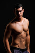 Photo : Healthy muscular young man. Isolated on black background. Healthy muscular young man. Isolated on black background.