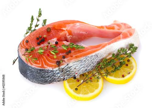 Photo: Red fish with lemon and thyme isolated on white. Red fish with lemon and thyme isolated on white.