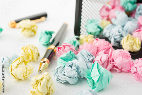 Photo: Garbage bin with paper waste with pen Garbage bin with paper waste with pen