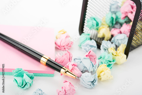 Photo: Garbage bin with paper waste with pen Garbage bin with paper waste with pen