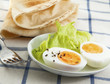 Photo: Hard boiled egg with salad on the textile background Hard boiled egg with salad on the textile background