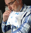 homme senior soufflant dans un éthylotest