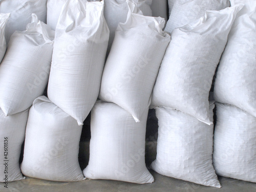 Photo: White sacks full with sand and rock White sacks full with sand and rock