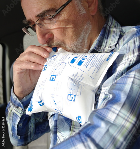 Photo: homme senior soufflant dans un éthylotest homme senior soufflant dans un éthylotest