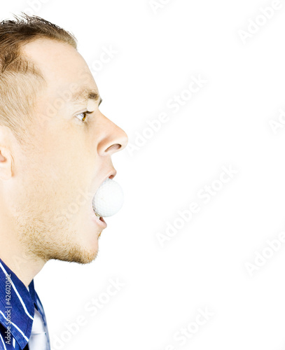 Photo: Man with golf ball in mouth Man with golf ball in mouth