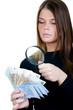 Woman with magnifying glass and euro cash money