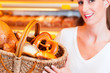 Female baker selling bread in her bakery