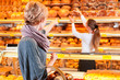 Photo : Salesperson with female customer in bakery Salesperson with female customer in bakery