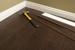 Photo: Hammer, Laminate Flooring and New Baseboard Molding Hammer, Laminate Flooring and New Baseboard Molding