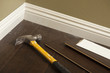 Photo: Hammer, Laminate Flooring and New Baseboard Molding Hammer, Laminate Flooring and New Baseboard Molding