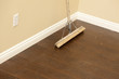 Photo: Push Broom on a Newly Installed Laminate Floor and Baseboard Push Broom on a Newly Installed Laminate Floor and Baseboard