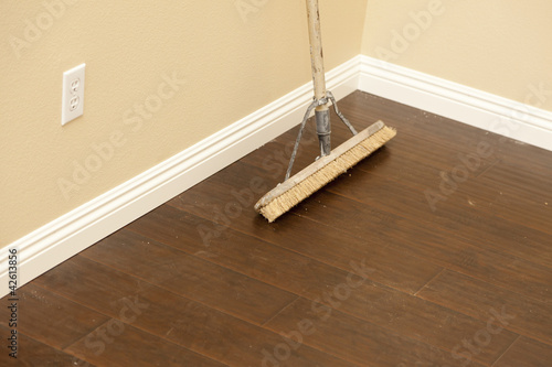 Photo: Push Broom on a Newly Installed Laminate Floor and Baseboard Push Broom on a Newly Installed Laminate Floor and Baseboard