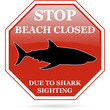 Beach closed due to shark sighting red sign.
