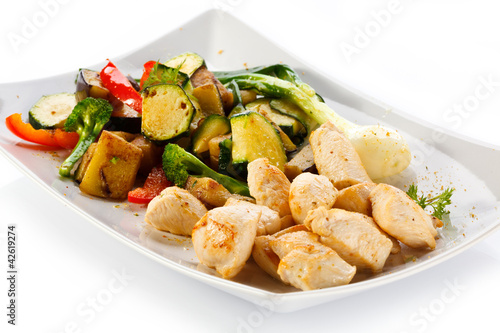 Photo: Grilled meat and vegetables on white background Grilled meat and vegetables on white background