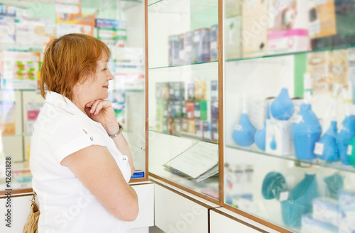 Photo: Mature woman r in pharmacy Mature woman r in pharmacy