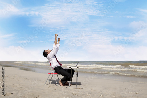 Photo: Successful businessman at beach Successful businessman at beach