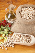 Photo: Burlap sack with chickpeas spilling out over a white background Burlap sack with chickpeas spilling out over a white background