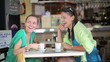 Video: Two excited female friends in the cafe looking at something Two excited female friends in the cafe looking at something