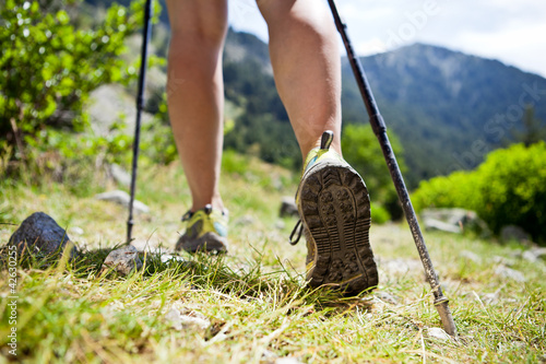Photo: Nordic walking legs in mountains Nordic walking legs in mountains