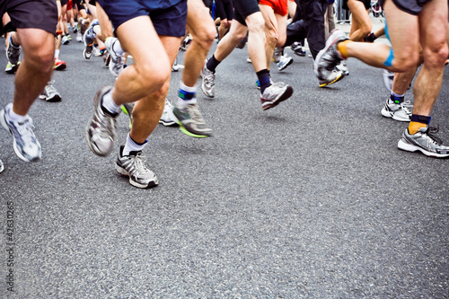 Photo: People running marathon on city street People running marathon on city street