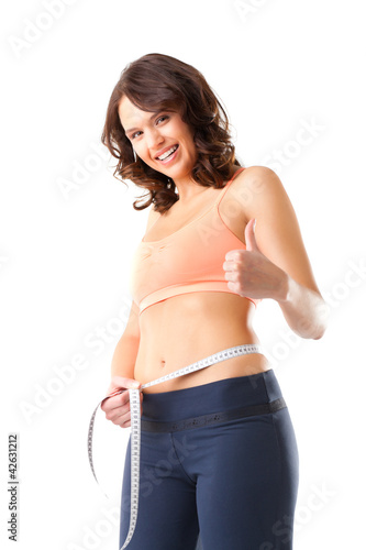 Photo: Diät - junge Frau misst Taille zum Abnehmen Diät - junge Frau misst Taille zum Abnehmen