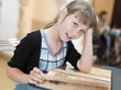 The girl the teenager looks the cafe menu