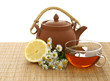 Foto: cup of tea and clay teapot cup of tea and clay teapot