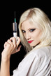 Foto: Smiling beautiful young girl in the image of nurse with syringe Smiling beautiful young girl in the image of nurse with syringe