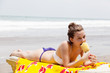 beautiful girl sunbathes on a tropical beach